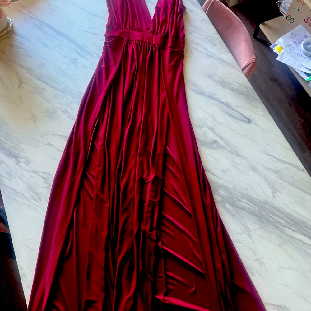 Long maroon dress with two slits on each side of the leg. Halter top style